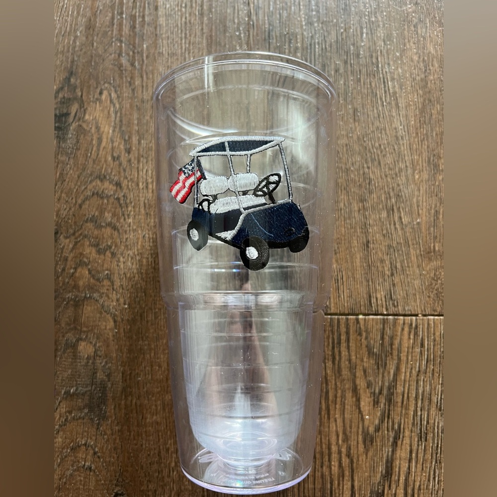 Like new 24 oz Tervis cup with Blue golf cart with American flags. No lid.